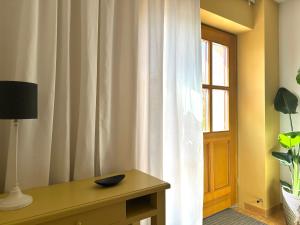a room with a table and a window with curtains at Fuchsbau-eine Auszeit für die Seele in Kritzmow