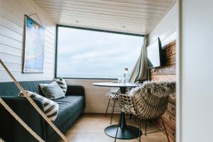 a living room with a couch and a table at Tiny Seaside - Kegnæs in Østerby