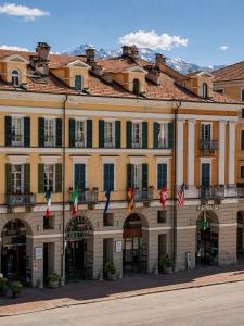 a large building with flags in front of it at Phi Hotel Principe in Cuneo