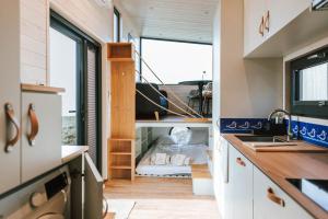 a tiny kitchen with a sink and a window at Tiny Seaside - Kegnæs in Østerby