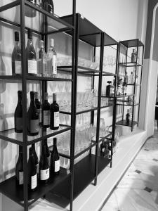a shelf filled with bottles of wine in a room at Tinion Hotel in Tinos
