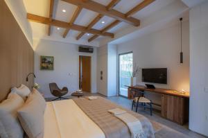 a bedroom with a large bed and a television at Trioda Kazdağları in Ayvacık