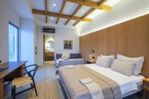 a bedroom with a large bed and a desk and a bed at Trioda Kazdağları in Ayvacık