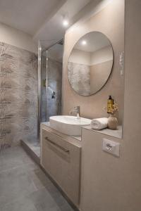 a bathroom with a sink and a mirror at Il Ritrovo Rooms in Petralia Sottana