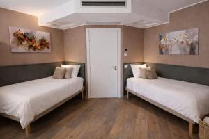 two beds sitting next to each other in a room at Il Ritrovo Rooms in Petralia Sottana