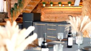 a table with glasses and bottles of wine on it at Metsapiiga Talu in Vilina +7 photos
