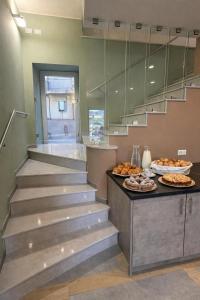 a staircase with some plates of food on a counter at Il Ritrovo Rooms in Petralia Sottana +17 photos