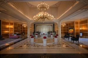 a lobby with a large room with a chandelier at The Leela Palace Jaipur in Jaipur