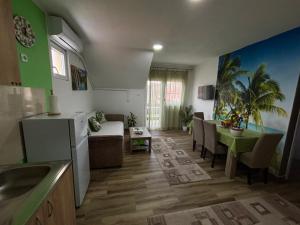 a living room with a kitchen and a dining room at Vila Mir Banja Vrujci in Gunjica