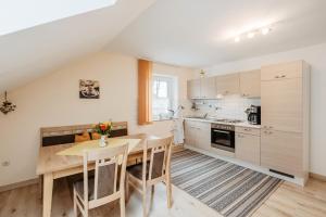 a kitchen with a wooden table and a dining room at Ferienwohnung Pietzavka in Wiesenfelden +20 photos