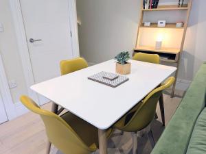 a meeting room with a white table and chairs at The Mews with free parking in York