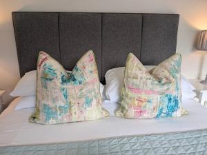 two pillows sitting on top of a bed at The Mews with free parking in York
