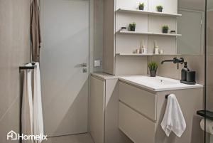 a bathroom with a sink and a shower at Zoi Suite - fully renovated luxury apartment in Chalkida +19 photos
