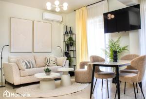a living room with a couch and a table at Zoi Suite - fully renovated luxury apartment in Chalkida