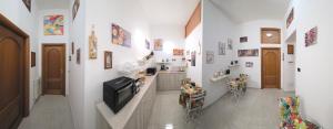 a hallway with white walls and a tv on a counter at Il Viandante in Catanzaro