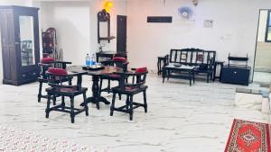 a room with a table and chairs on a tile floor at HOTEL SHREE JMM s14 near by in Udaipur