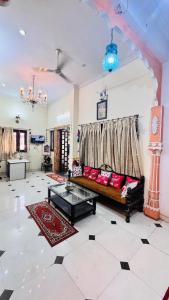 a living room with a couch and a table at HOTEL SHREE JMM s14 near by in Udaipur