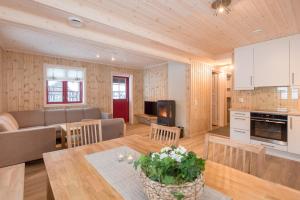 a kitchen and living room with a table and a couch at Rauland Feriesenter in Rauland