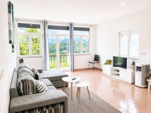 a living room with a couch and a tv at Casa de Casarelhos - "Gerês" in Geres