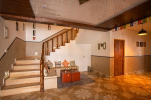 a staircase in a building with a bench and a suitcase at PACK Sissu in Sissu