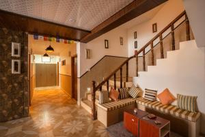 a living room with a couch and stairs at PACK Sissu in Sissu