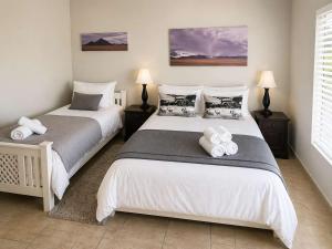 a bedroom with two beds with towels on them at Sunset View 10 @ Langstrand in Langstrand