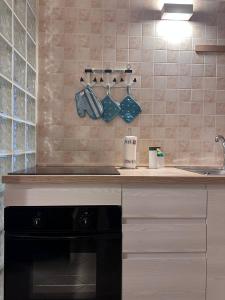 a kitchen with a stove and a counter with a sink at La Piccola Dimora in Giovinazzo
