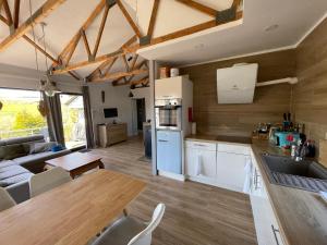 a kitchen and living room with a table and a couch at Ferienhaus am Hennesee in Meschede