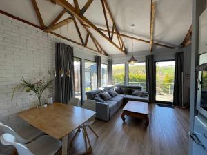 a living room with a couch and a table at Ferienhaus am Hennesee in Meschede