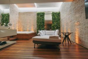 a bathroom with a bed and a bath tub at Luna Blu Concept in Curitiba