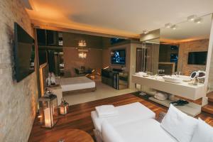 a large bathroom with a white couch and a sink at Luna Blu Concept in Curitiba