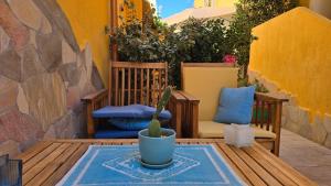 a patio with two chairs and a cactus on a table at Casa Stelle Marine in Palau