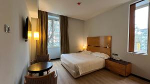 a hotel room with a bed and a table and chairs at Hotel Igea in Brescia +109 photos