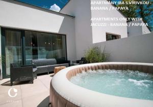 a hot tub in the middle of a patio at JUMBO APARTMENTS in Rajecké Teplice