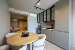 a kitchen and dining room with a wooden table and chairs at Villa Vita Mare in Preko