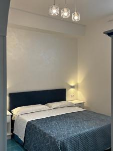 a bedroom with a large bed with two lights above it at Luisa apartments, Coastal escape on the Amalfi Coast! in Furore