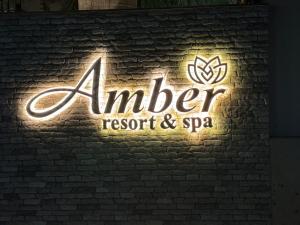 a sign for aier resort and spa on a brick wall at Amber Resort & Spa in Indore
