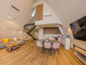 a large living room with a table and chairs at Lotus 2 in Goruna