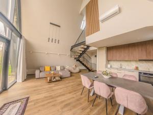 a kitchen and living room with a table and chairs at Lotus 2 in Goruna
