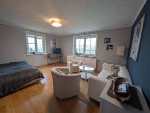 a bedroom with a bed and a living room at Ferienwohnung Lachen in Lachen