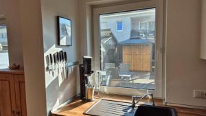a kitchen with a desk with a window and a laptop at Ferienwohnung BungertOase in Saarburg