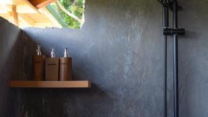 a shelf with three knives on a wall at Nari Swari Sidemen in Karangasem