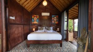 a bedroom with a bed in a wooden room at Nari Swari Sidemen in Karangasem