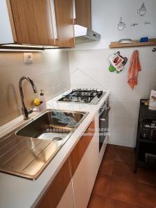 a kitchen with a sink and a stove at CasAmare in Francavilla al Mare