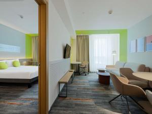 a hospital room with a bed and tables and chairs at ibis Styles Chisinau in Chişinău +58 photos
