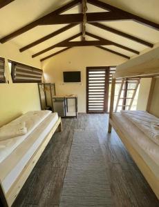 a room with two beds and a tv in it at Anchor Boutique- Clisura Dunării in Liborajdea