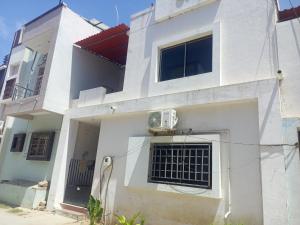 a white house with a fan on the side of it at Madhav Villa Only Family in Dwarka