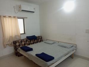 a small room with a bed and a window at Madhav Villa Only Family in Dwarka