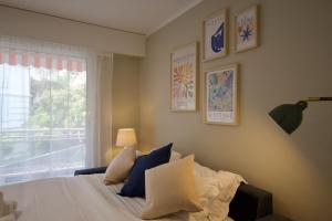 a bedroom with a bed with pillows and a window at Monte Carlo Terrace Monaco in Beausoleil