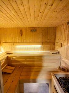 an inside of a sauna with wooden walls and ceilings at Apartament Ski &Sun in Świeradów-Zdrój